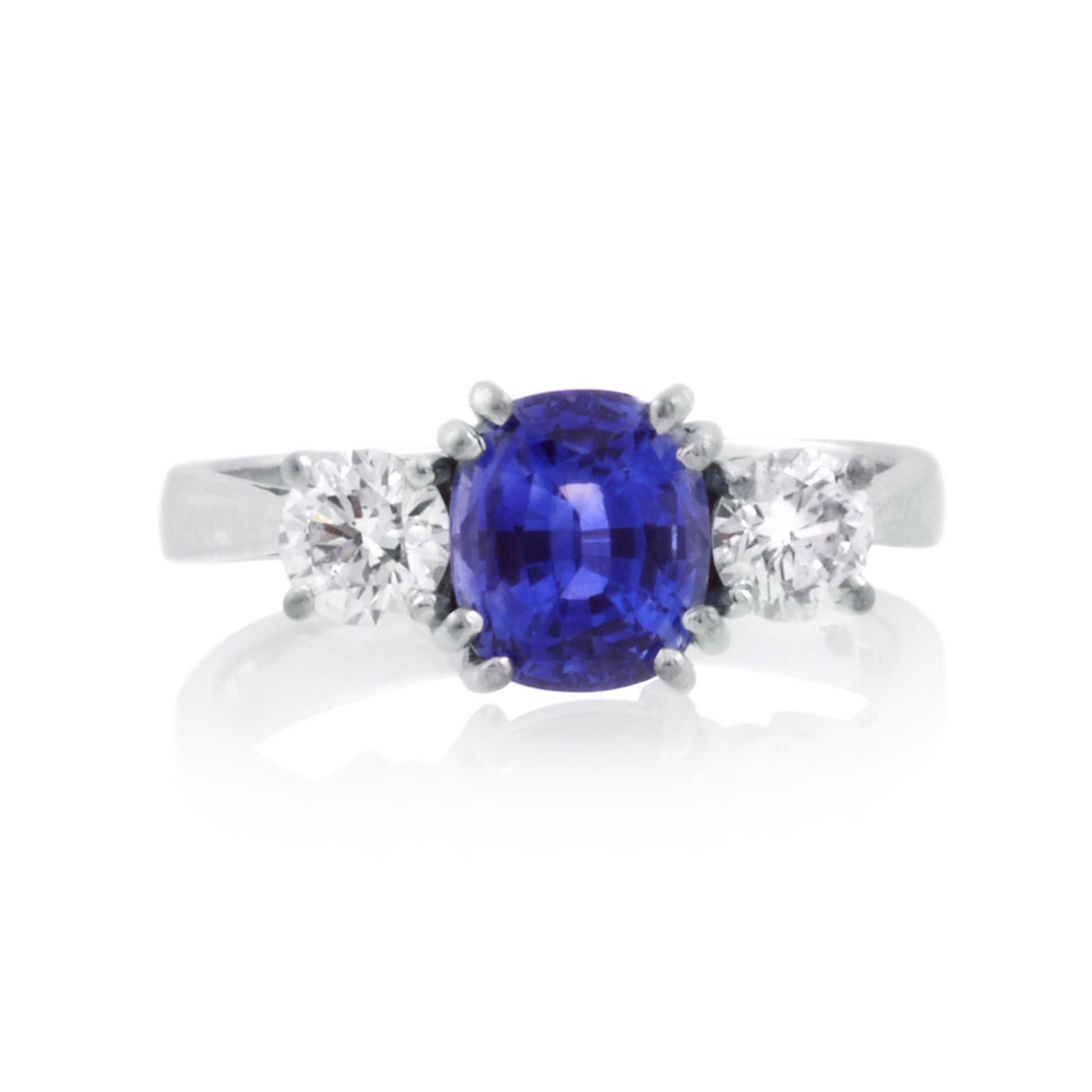 An 18ct white gold, sapphire and brilliant cut diamond set three stone ring.