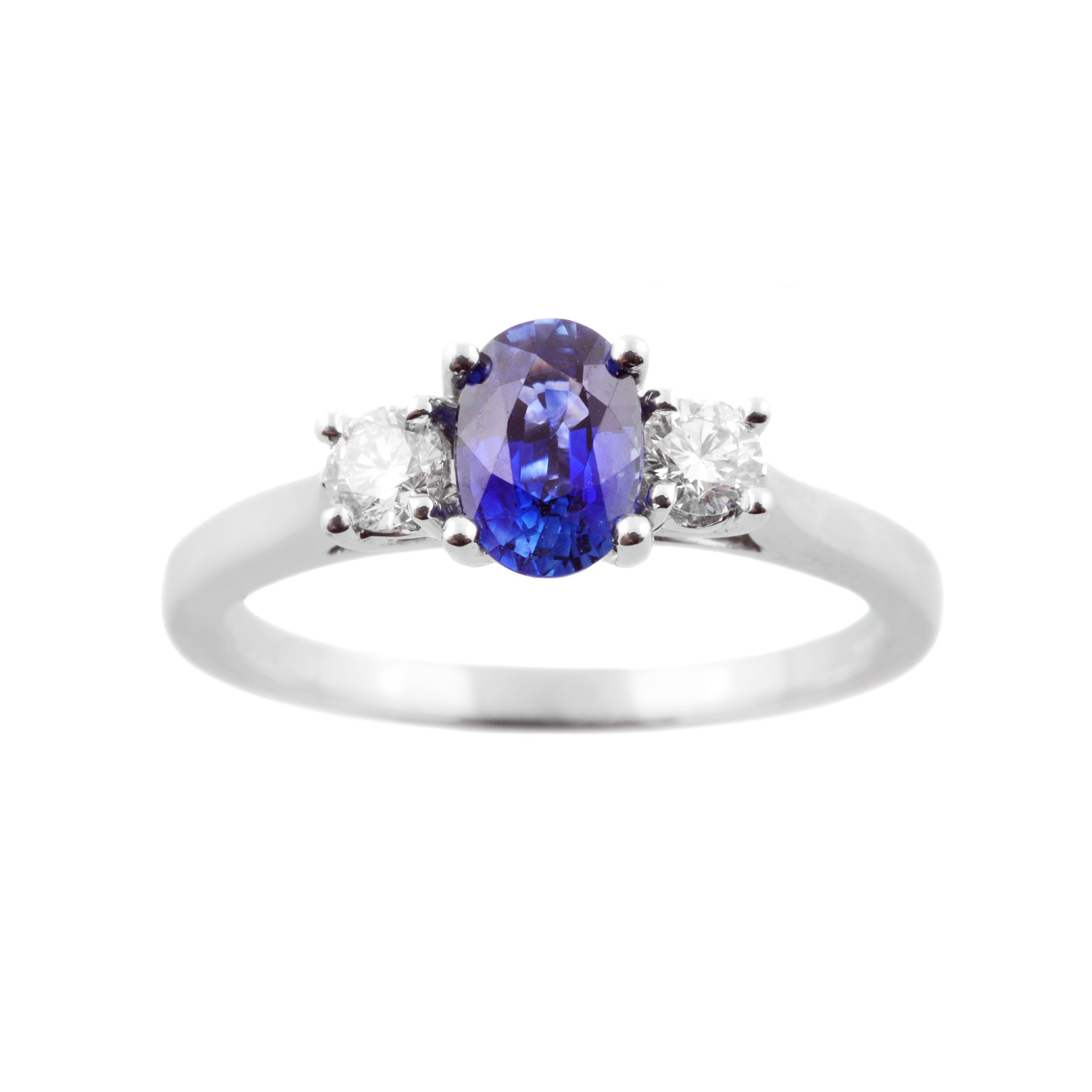 An 18ct white gold oval sapphire and diamond set three stone ring.