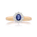 An 18ct gold, oval sapphire and brilliant cut diamond set cluster ring.