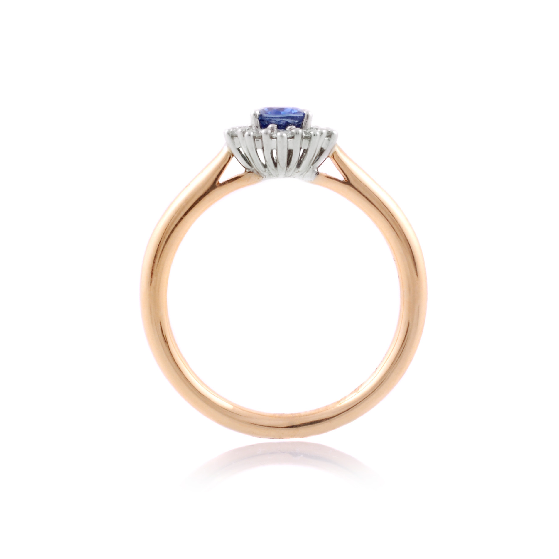 An 18ct gold, oval sapphire and brilliant cut diamond set cluster ring.