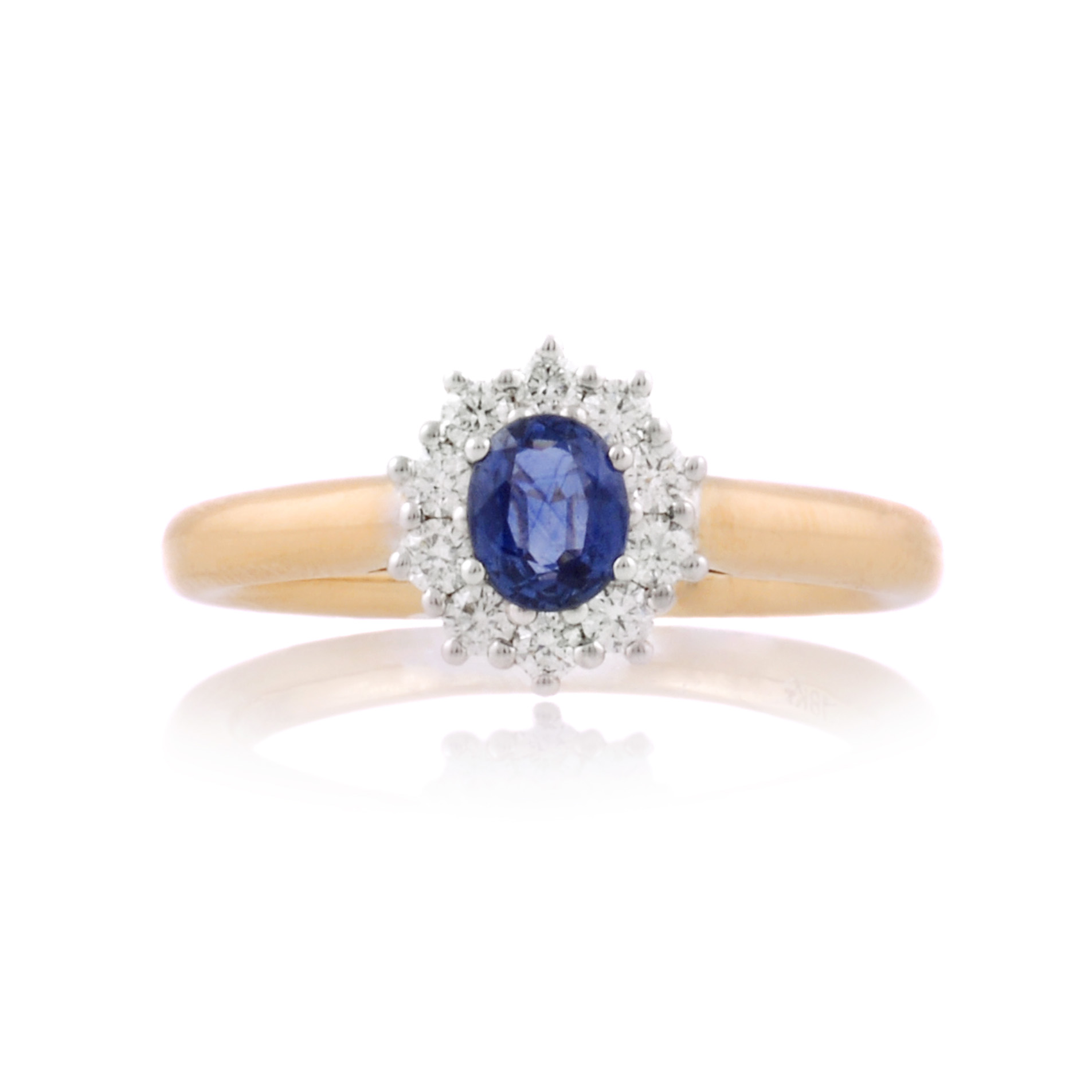 An 18ct gold, oval sapphire and brilliant cut diamond set cluster ring.