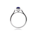 An 18ct white gold, oval shaped sapphire and diamond set cluster ring with diamond set shoulders.