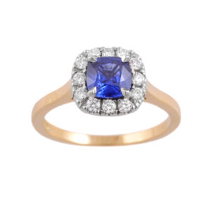 An 18ct yellow gold and platinum sapphire and diamond cluster ring. The central cushion shaped sapphire is surrounded by round brilliant cut diamonds.