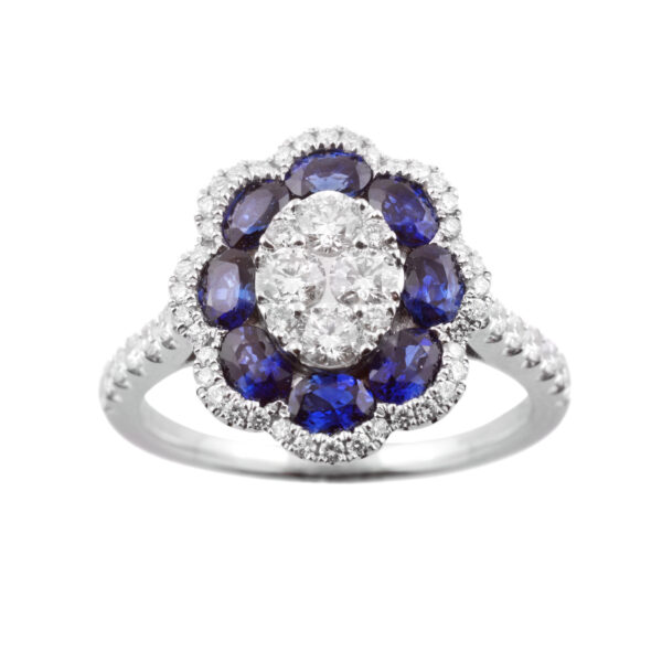 An 18ct white gold oval shaped sapphire and diamond flower cluster ring, with diamond set shoulders.