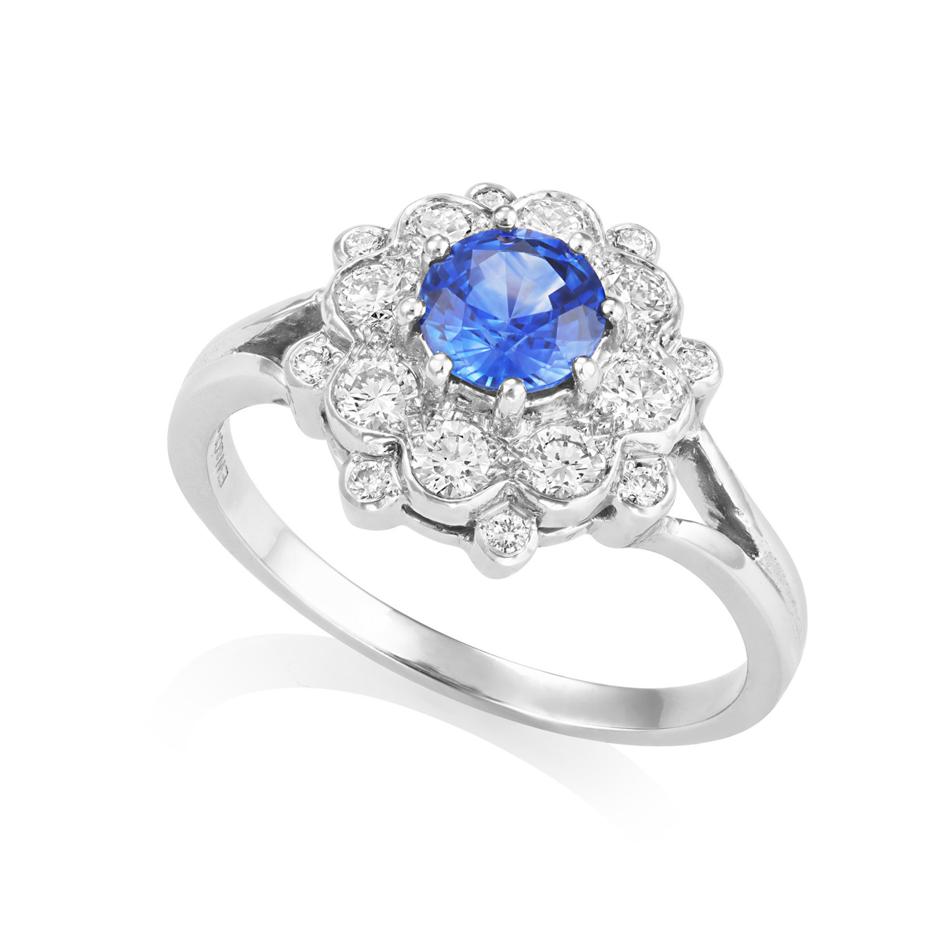 A platinum sapphire and diamond double tier cluster ring with split shoulders.