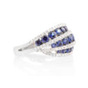 An 18ct white gold, sapphire and diamond swirl set dress ring.