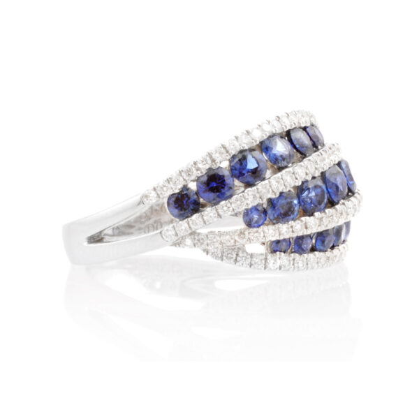 An 18ct white gold, sapphire and diamond swirl set dress ring.