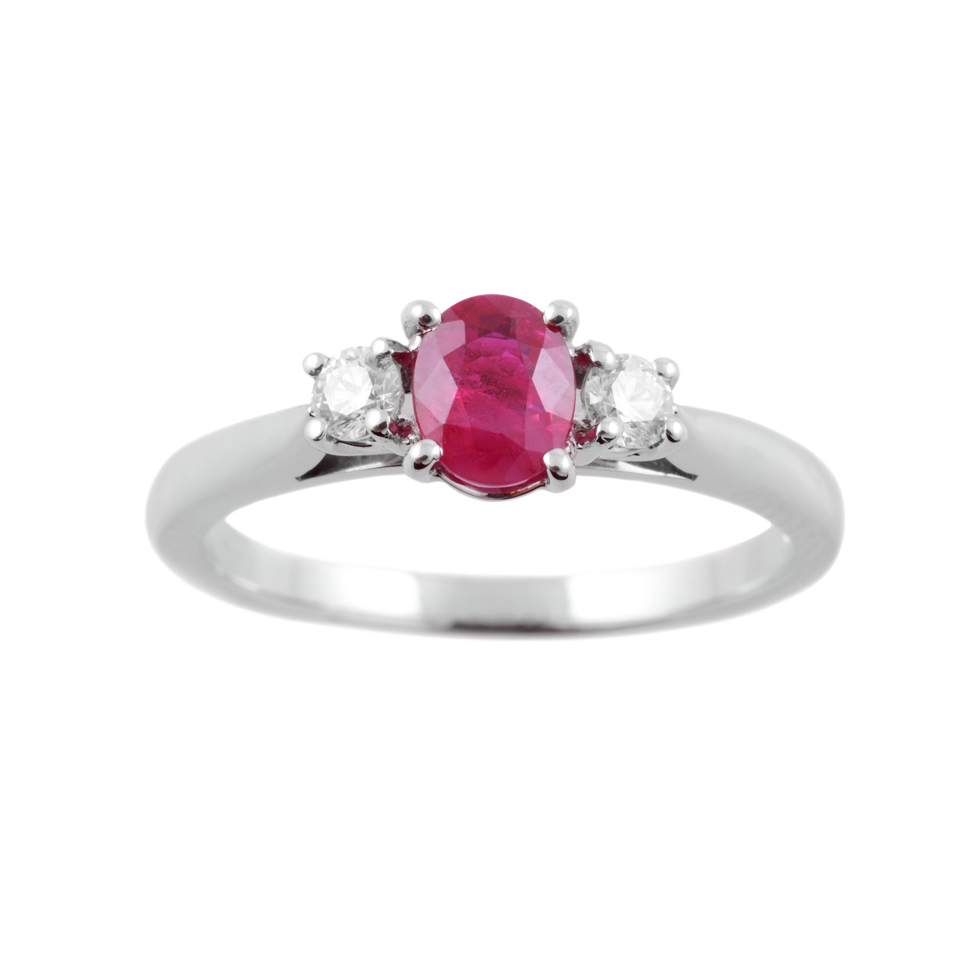 Platinum Oval & Brilliant Cut Diamond Three Stone Ring A platinum oval ruby and round brilliant cut diamond claw set three stone ring.
