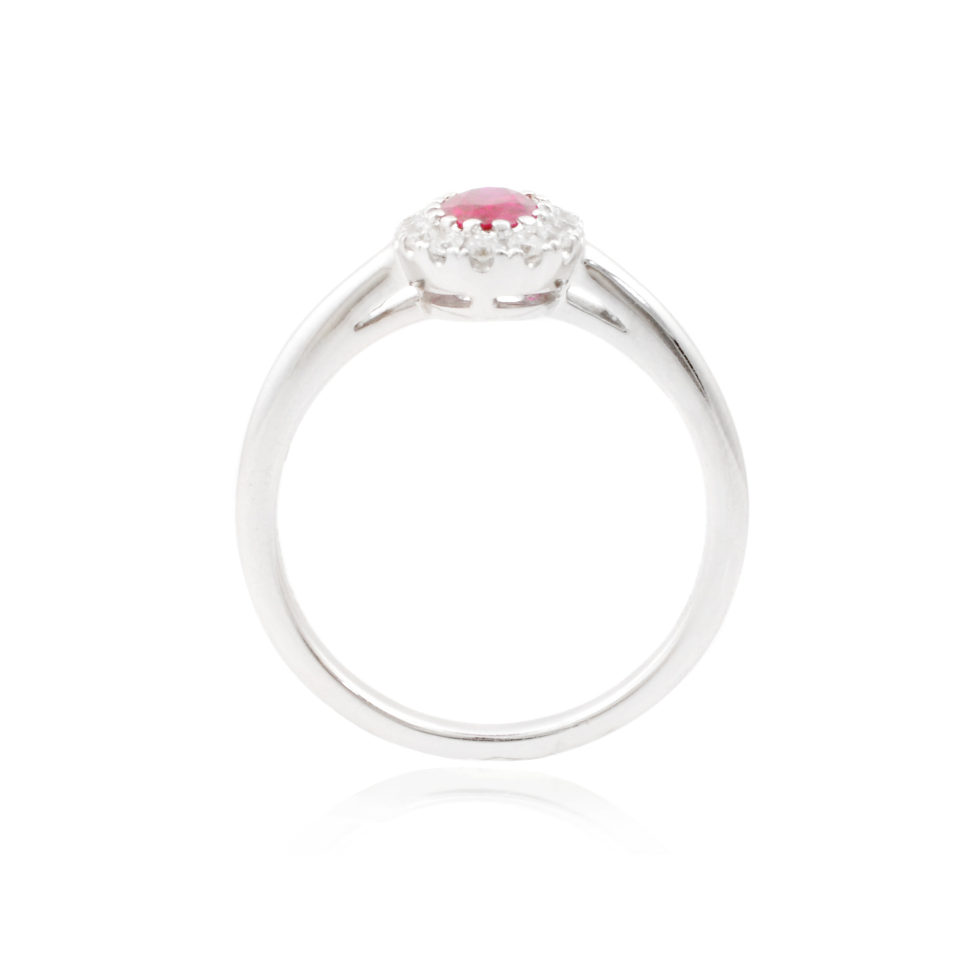 An 18ct white gold, oval ruby and diamond set cluster ring.