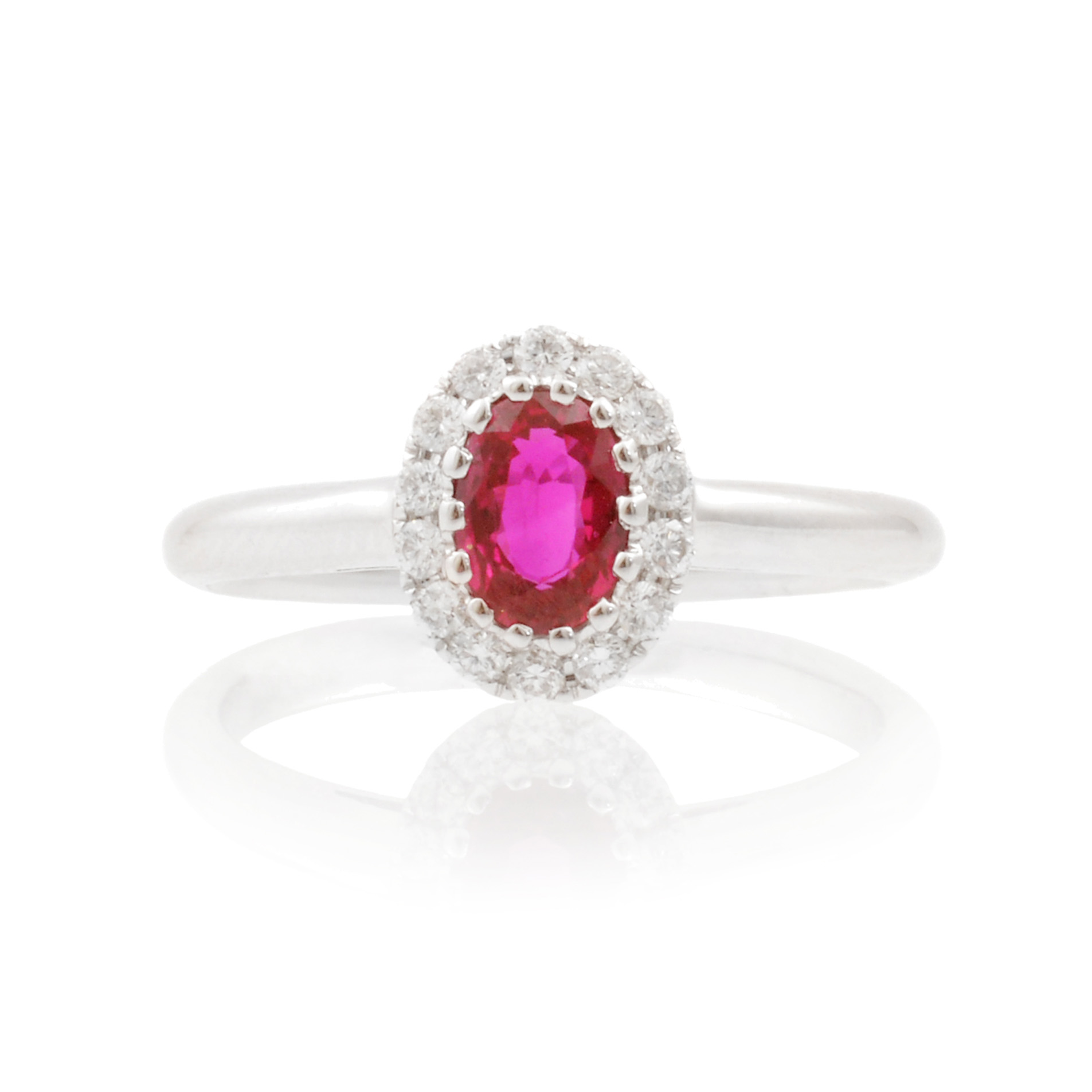 An 18ct white gold, oval ruby and diamond set cluster ring.