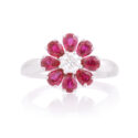 An 18ct white gold, ruby and diamond set flower cluster ring.