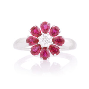 An 18ct white gold, ruby and diamond set flower cluster ring.