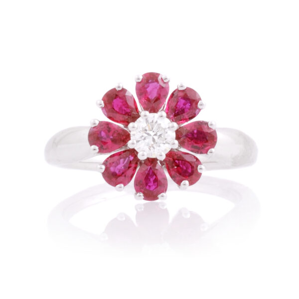 An 18ct white gold, ruby and diamond set flower cluster ring.