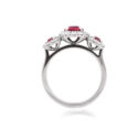 A platinum ruby and brilliant cut diamond set triple cluster ring.