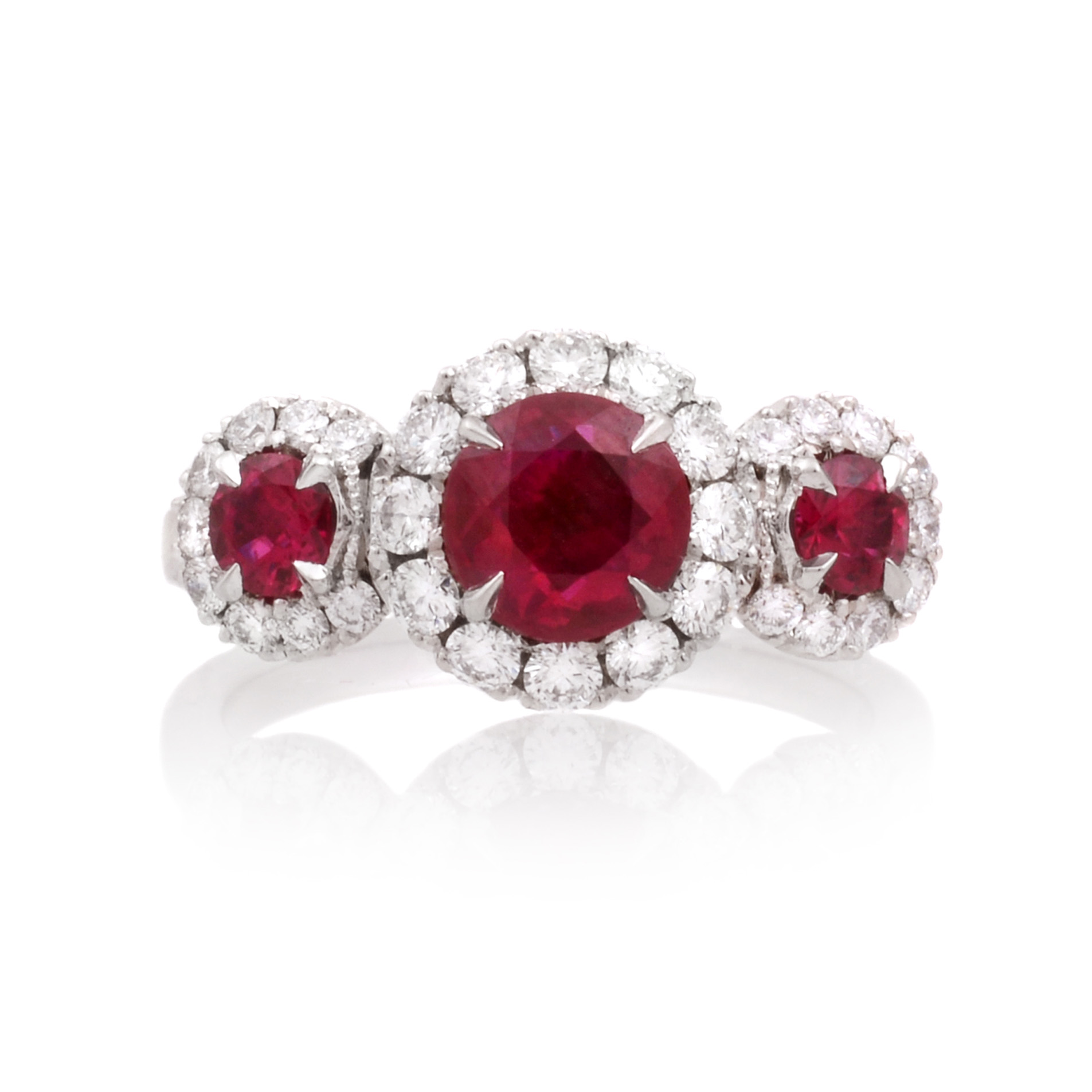 Platinum Ruby & Diamond Triple Cluster Ring A platinum ruby and brilliant cut diamond set triple cluster ring.