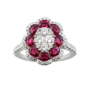 An 18ct white gold oval flower shaped ruby and diamond cluster ring, with diamond set shoulders.