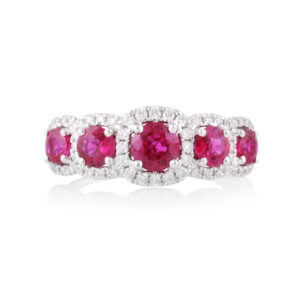 An 18ct white gold, ruby and diamond set five stone fancy cluster ring.