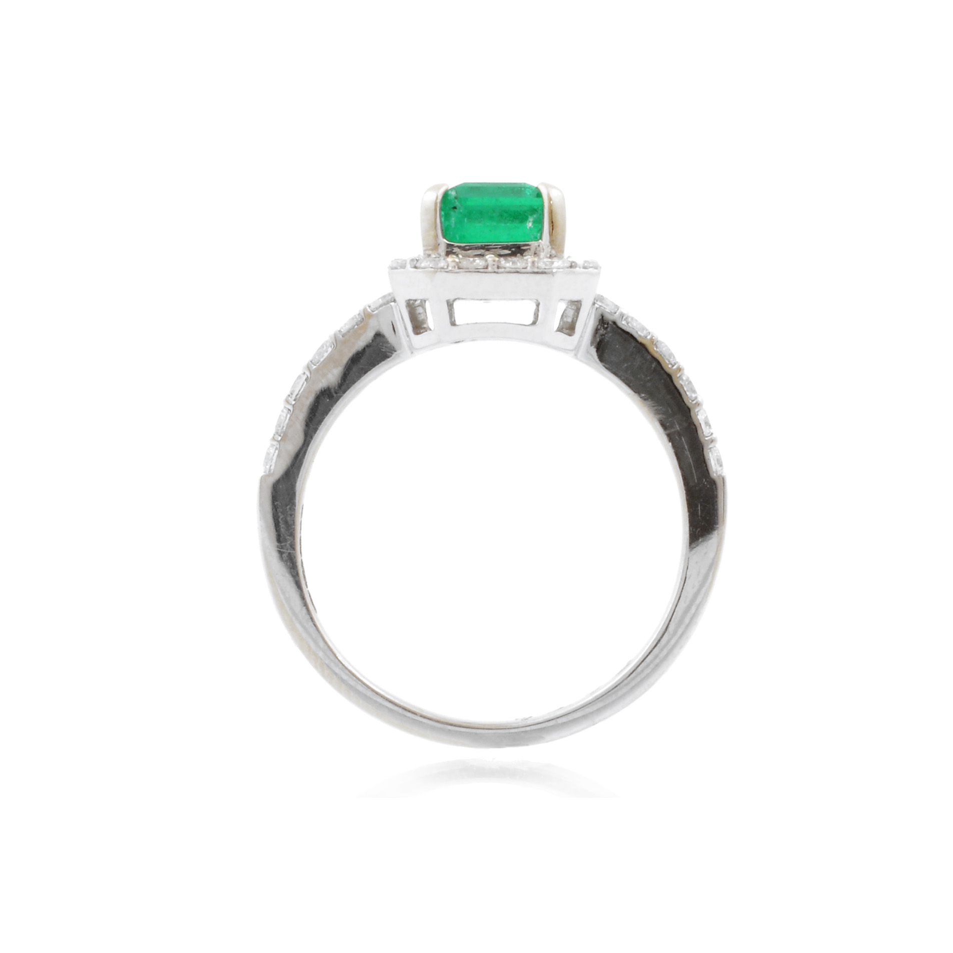 18ct White & Yellow Gold Emerald & Brilliant Cut Diamond Cluster Ring with Diamond Shoulders An 18ct white and yellow gold emerald and brilliant cut diamond cluster ring with diamond set shoulders.