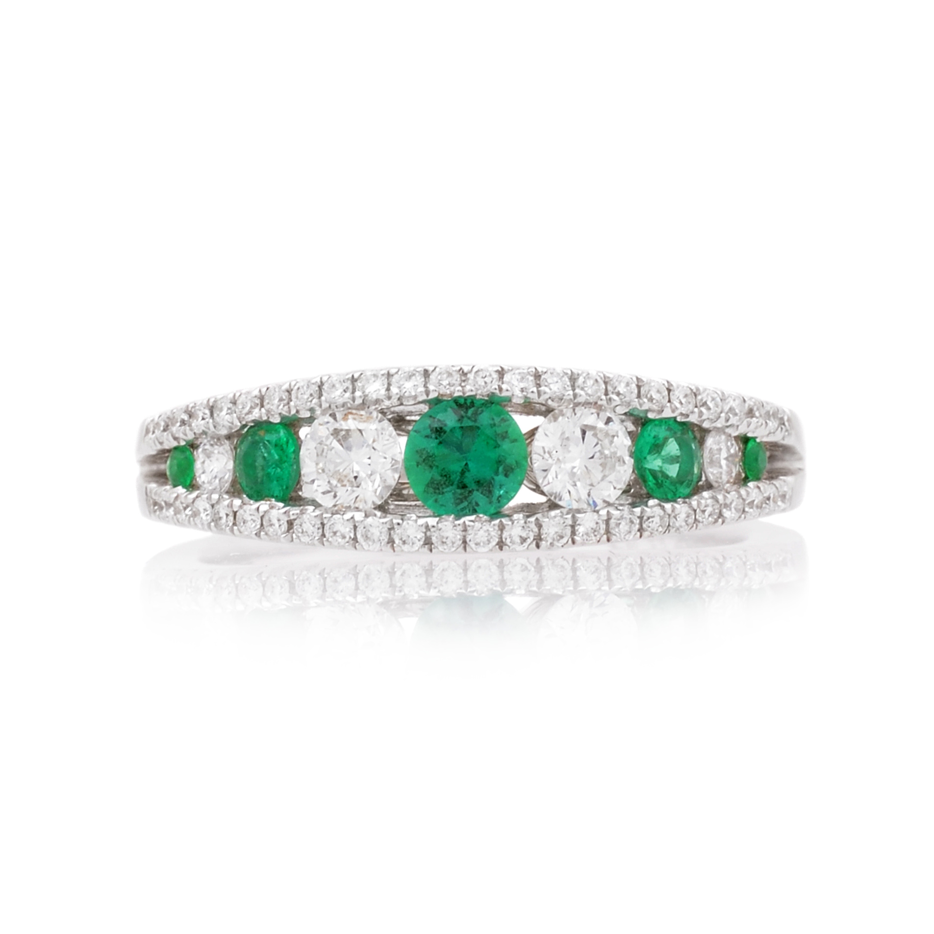 18ct White Gold Emerald & Diamond Fancy Ring An 18ct white gold, emerald and diamond set graduated fancy ring.