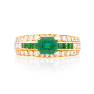 An 18ct yellow gold emerald and diamond set fancy ring.