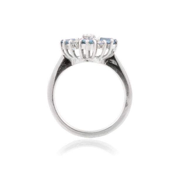 An 18ct white gold nine stone aquamarine and diamond set fancy cluster ring.