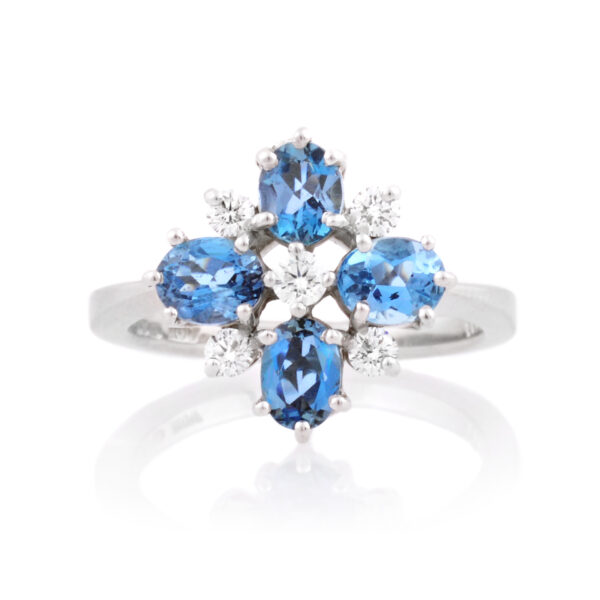 An 18ct white gold nine stone aquamarine and diamond set fancy cluster ring.