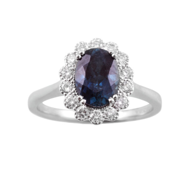 An 18ct white gold oval tourmaline and round brilliant cut diamond ring set with double claws and milligraining surrounding the diamonds.