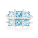 An 18ct white gold blue topaz six stone fancy cluster ring with diamonds set to the shoulders.