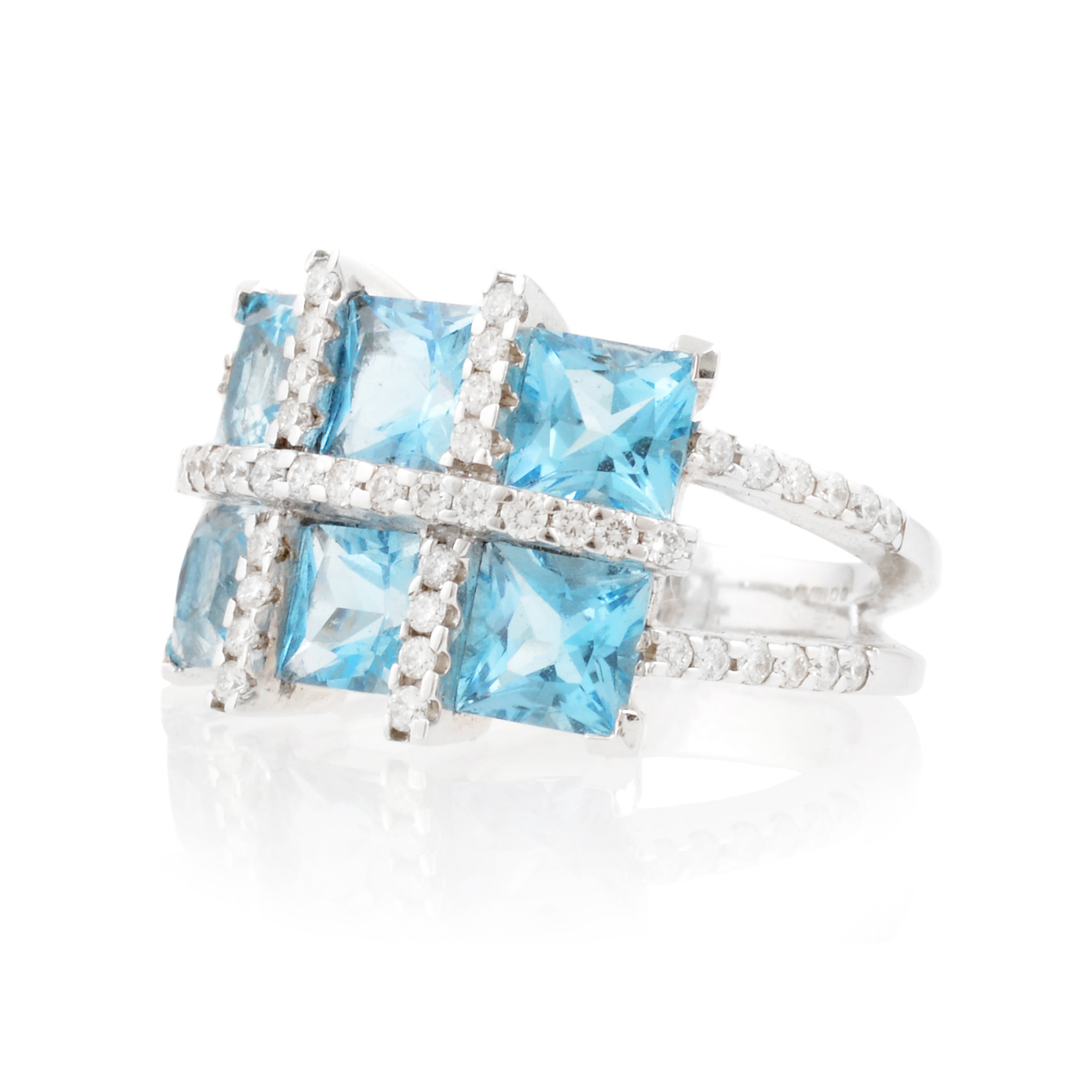 An 18ct white gold blue topaz six stone fancy cluster ring with diamonds set to the shoulders.