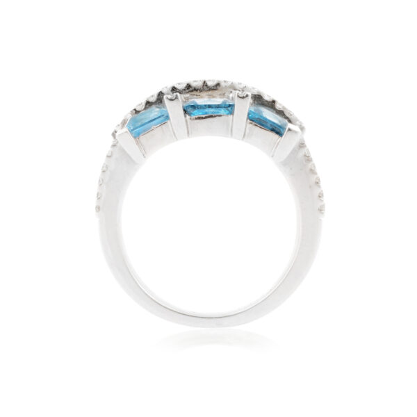 An 18ct white gold blue topaz six stone fancy cluster ring with diamonds set to the shoulders.