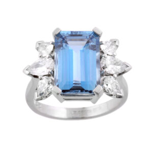 An 18ct white gold emerald cut aquamarine ring with pear shaped diamond set shoulders designed and mounted by H. L. Brown.