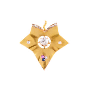 An 18ct yellow gold stylised ivy leaf with a ruby, sapphire and diamonds around a central single old European cut diamond. Circa 1890.