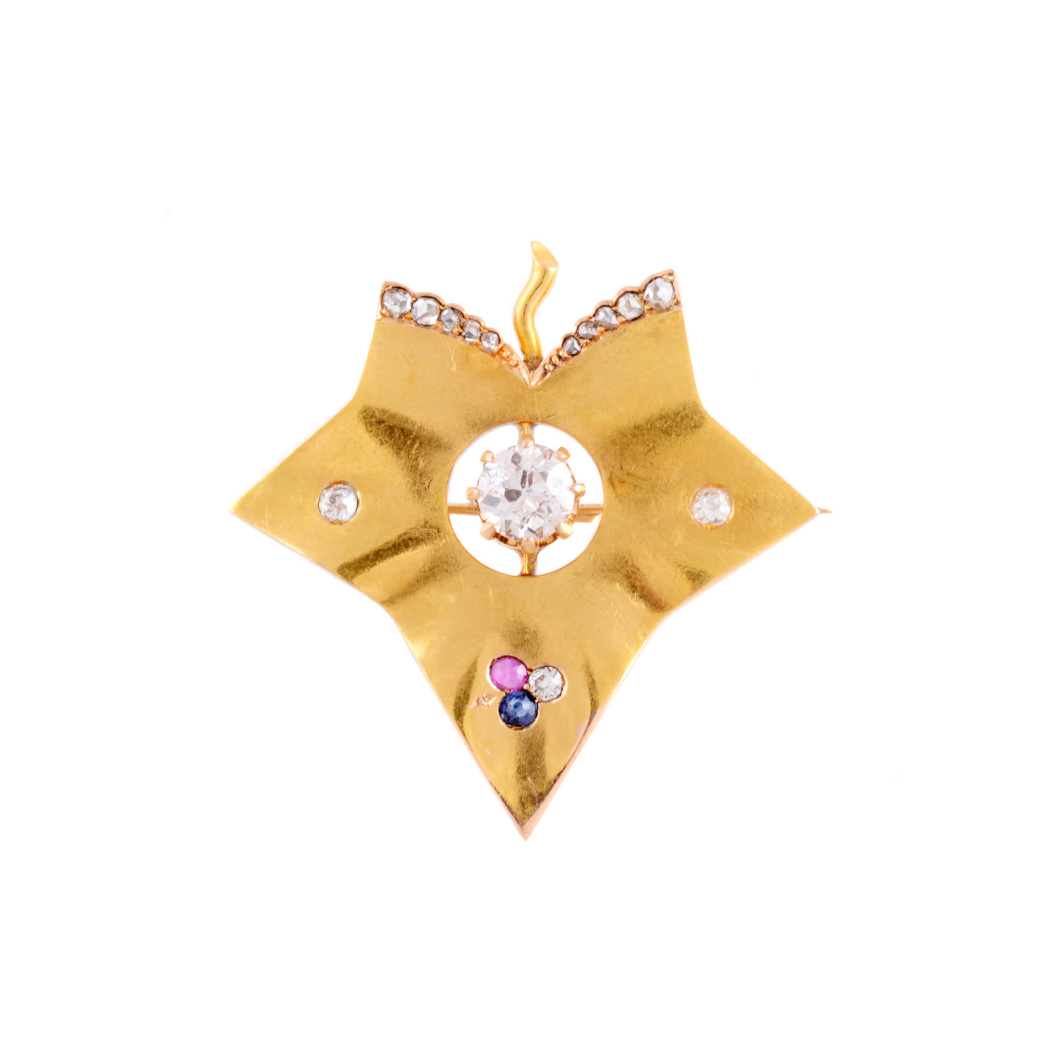 An 18ct yellow gold stylised ivy leaf with a ruby, sapphire and diamonds around a central single old European cut diamond. Circa 1890.