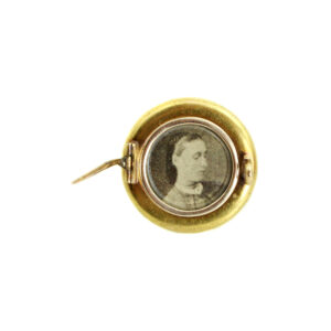 A Victorian era circular brooch with a pin that could also be worn as a locket on a chain.
