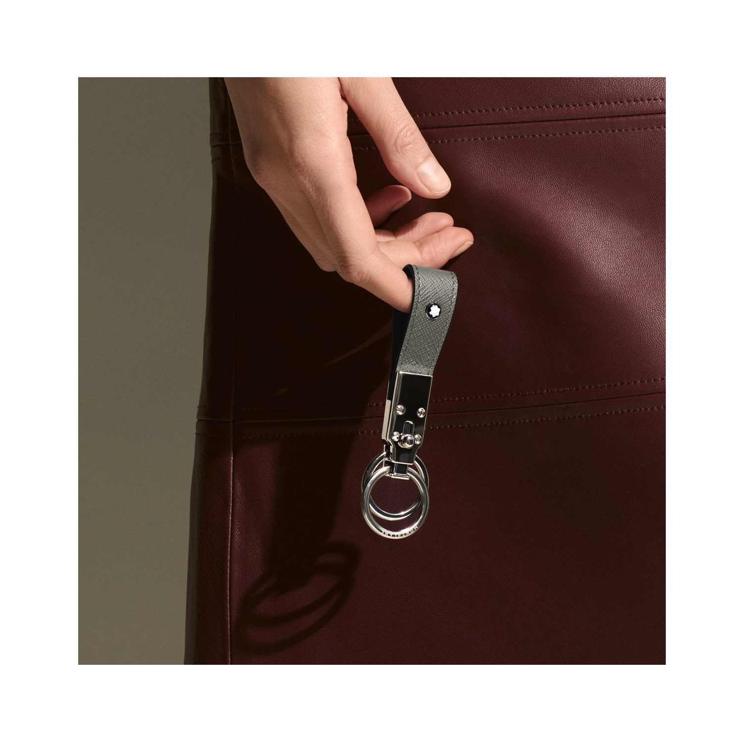 A Montblanc, Sartorial loop key fob crafted in medium grey Saffiano-printed leather and shaped into a loop, featuring increased functionality with the detachable ring to loop in several keys.