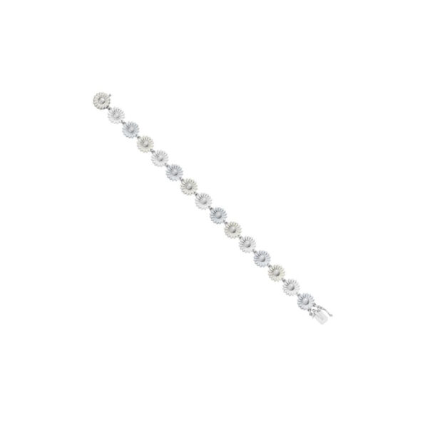 A rhodium plated, sterling silver bracelet with white enamelled flowers from Georg Jensen’s Daisy collection.