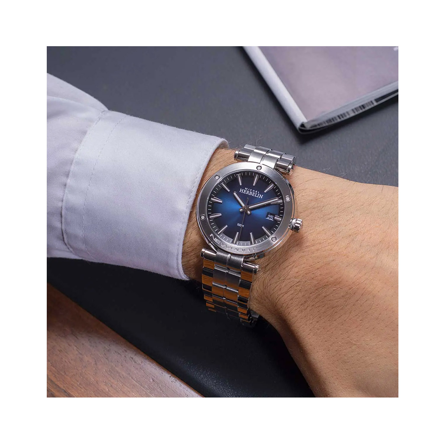 Herbelin, Newport with a 40.5mm stainless steel case and bracelet strap featuring a date function and a dark blue graduated dial.