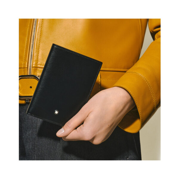 A Montblanc, Meisterstück card holder crafted in deep-shine black leather with an exterior credit card slot and three internal slots, a dedicated business card compartment featuring an extra small additional pocket.