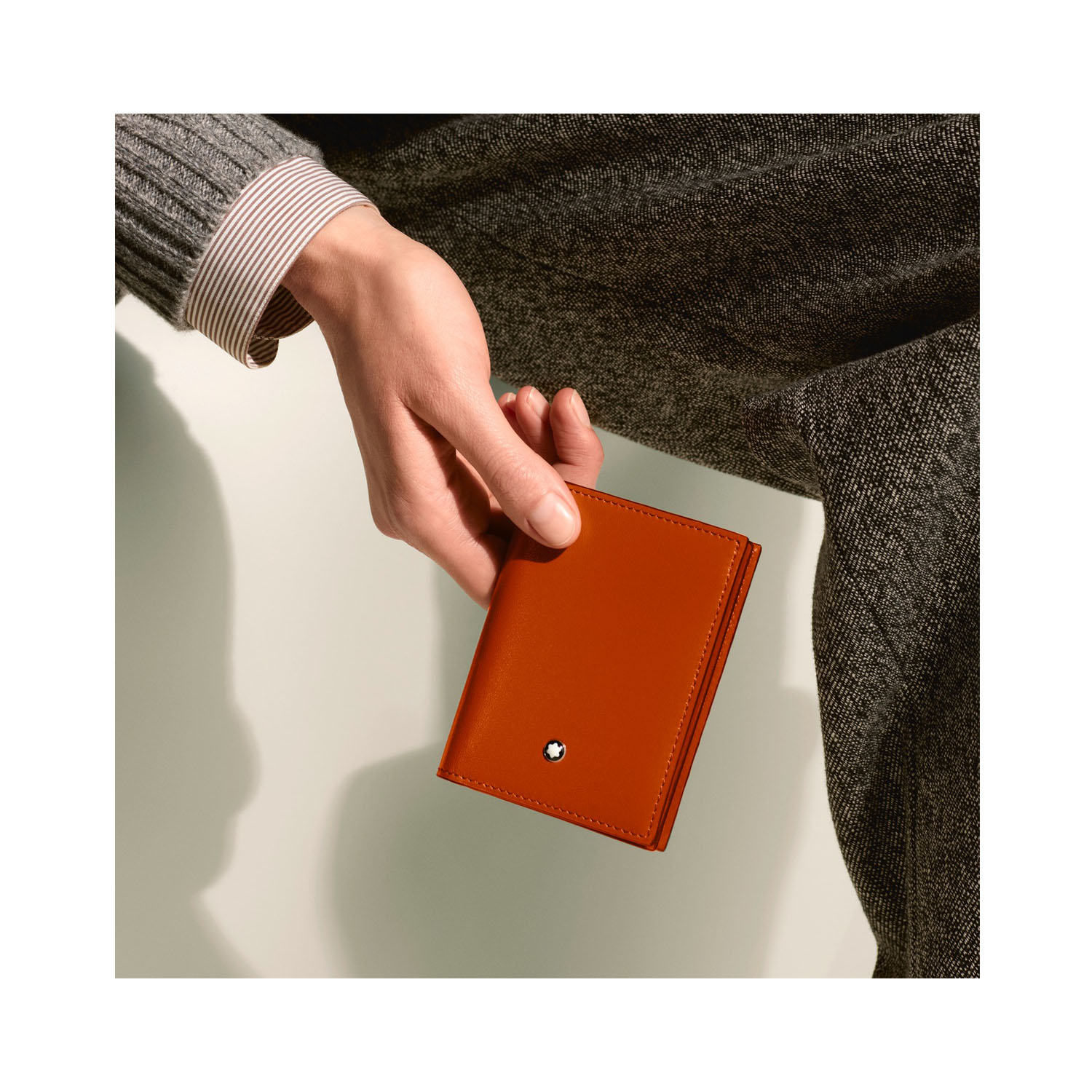 A Montblanc, Meisterstück card reader crafted in elegant rust-colour leather with four credit or business card slots.