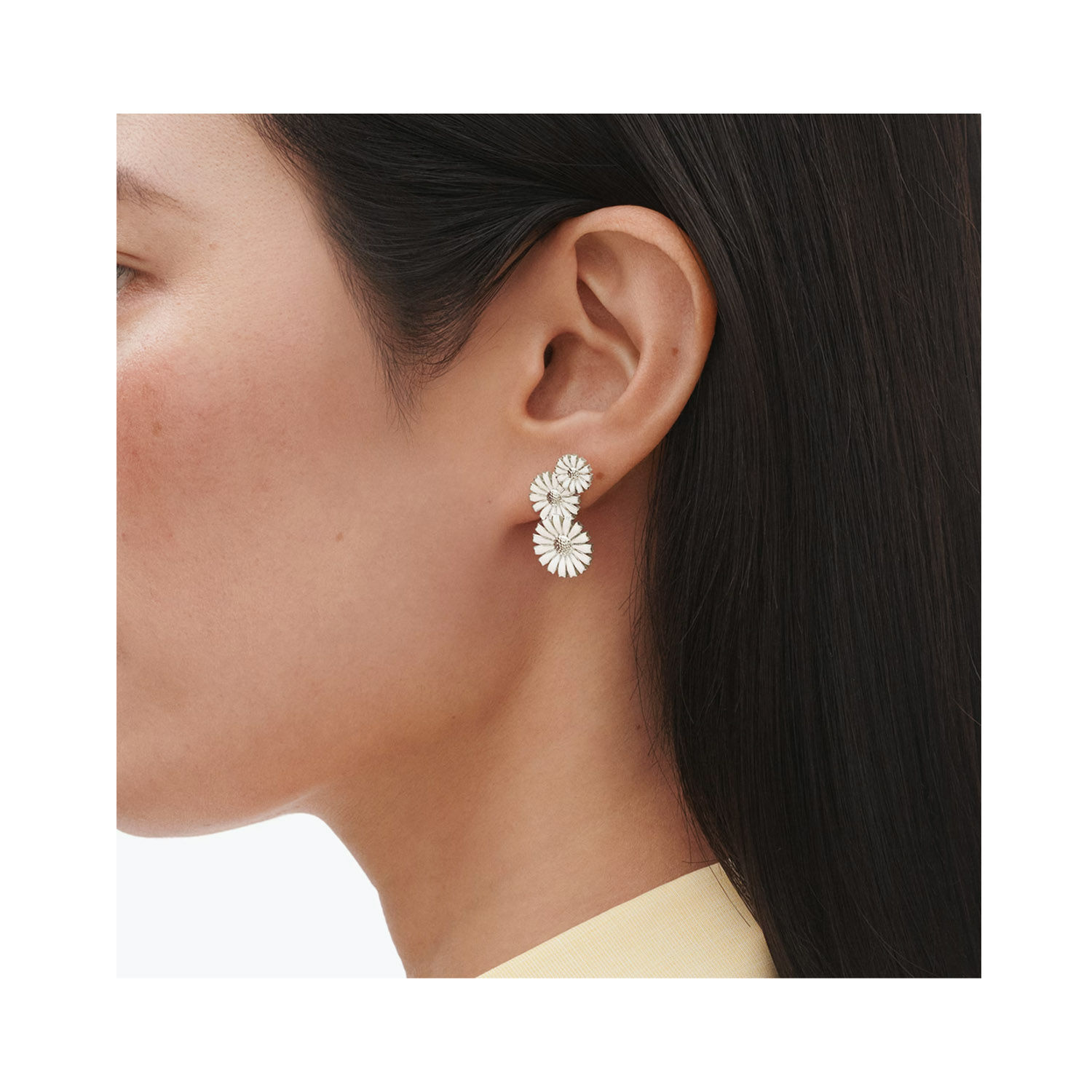 A pair of sterling silver white enamelled flower earrings, for pierced ears from Georg Jensen's Daisy collection.