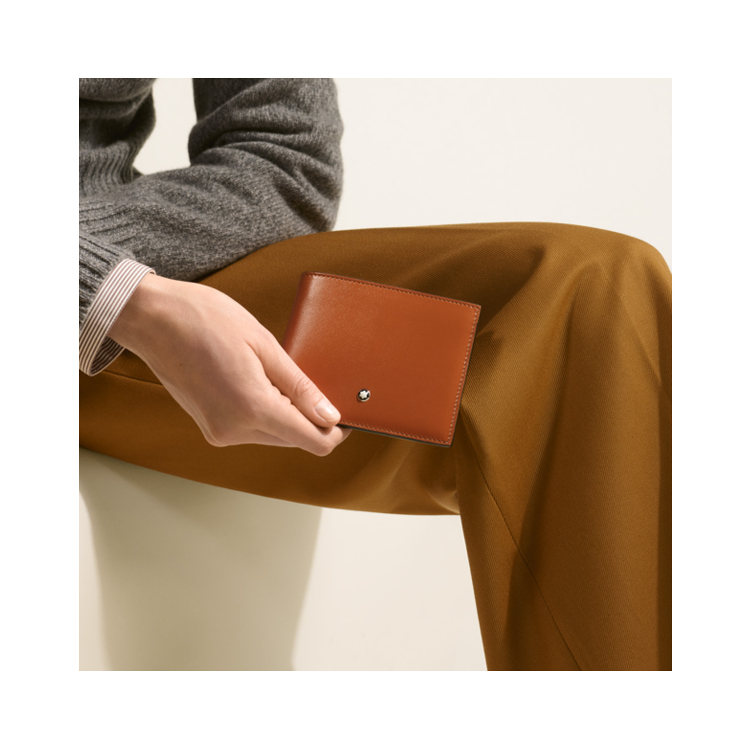 A Montblanc, Meisterstück wallet crafted in elegant rust-coloured leather with six credit card slots, two compartments for banknotes and two additional small pockets.