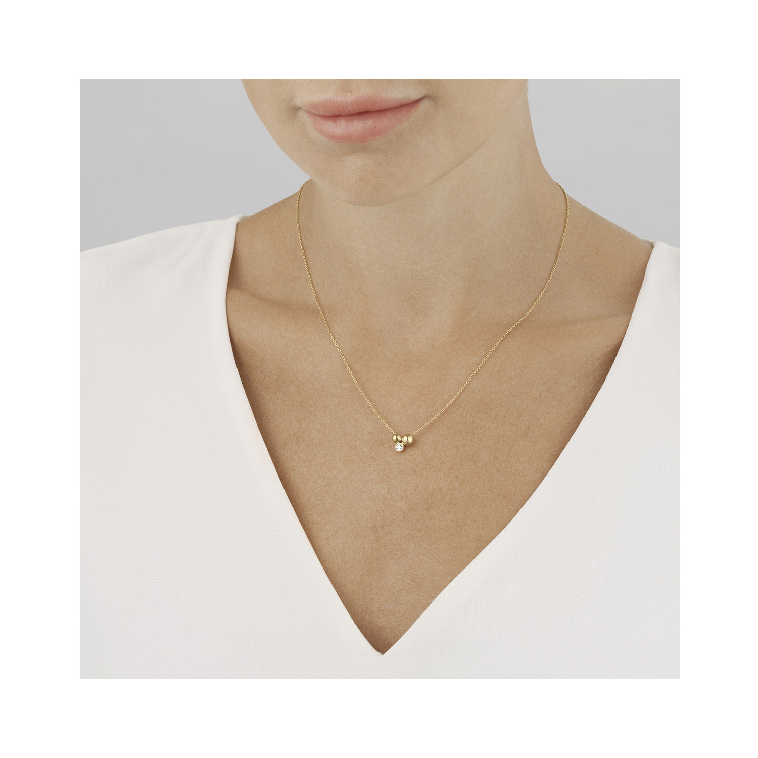 Georg Jensen, 18ct Yellow Gold Moonlight Grapes Diamond Set Pendant & Chain: 0.07 carats An 18ct yellow gold single stone diamond pendant and chain from Georg Jensen's Moonlight Grapes collection.