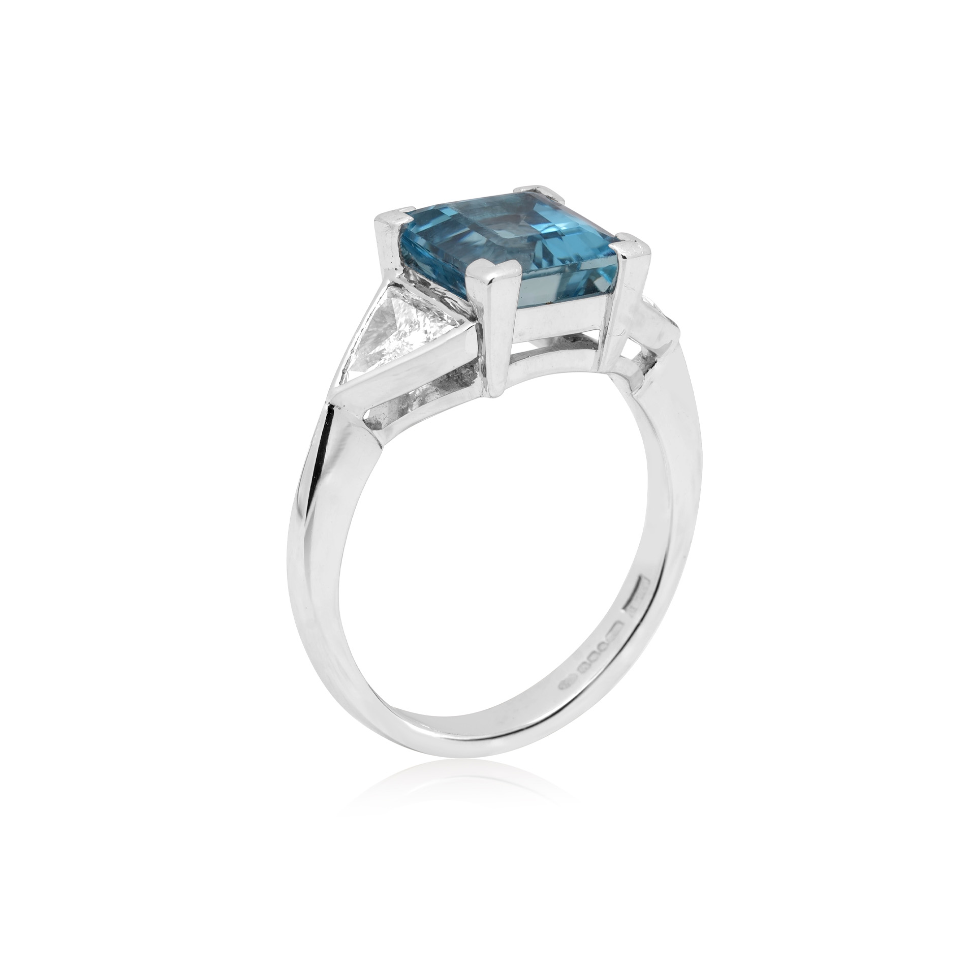 18ct White Gold Aquamarine & Diamond Three Stone Ring An 18ct white gold square cut aquamarine and brilliant cut diamond three stone ring, with brilliant cut diamonds set to the shoulders.