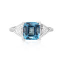 An 18ct white gold square cut aquamarine and brilliant cut diamond three stone ring, with brilliant cut diamonds set to the shoulders.