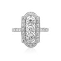A platinum diamond plaque ring with rubover and millegrain settings and diamond set shoulders.