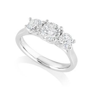 A platinum brilliant cut diamond three stone ring with a crossover decorated gallery.