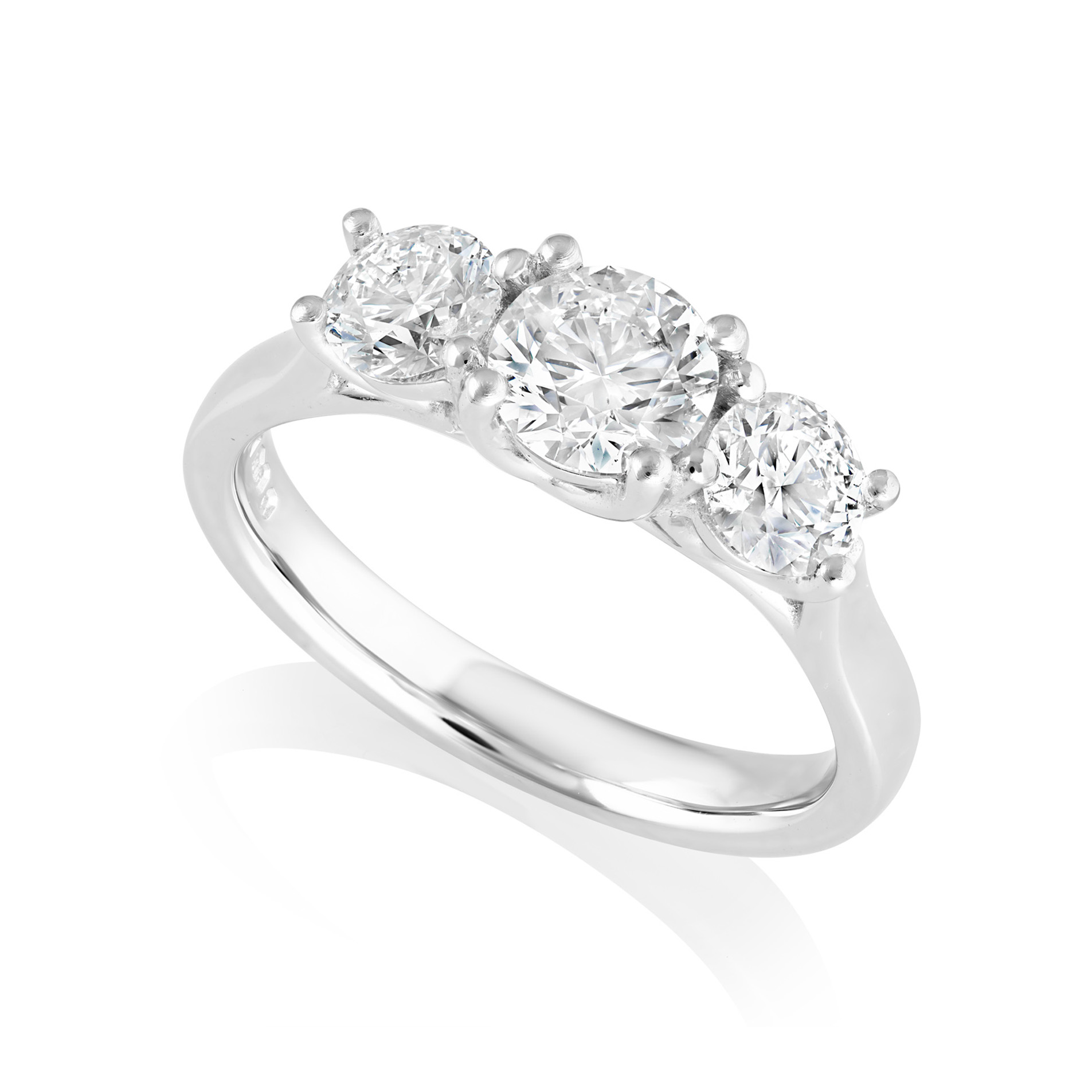 A platinum brilliant cut diamond three stone ring with a crossover decorated gallery.