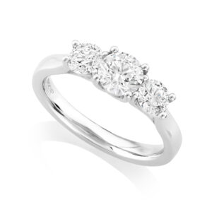 A platinum brilliant cut three stone diamond ring with a crossover decorated gallery.