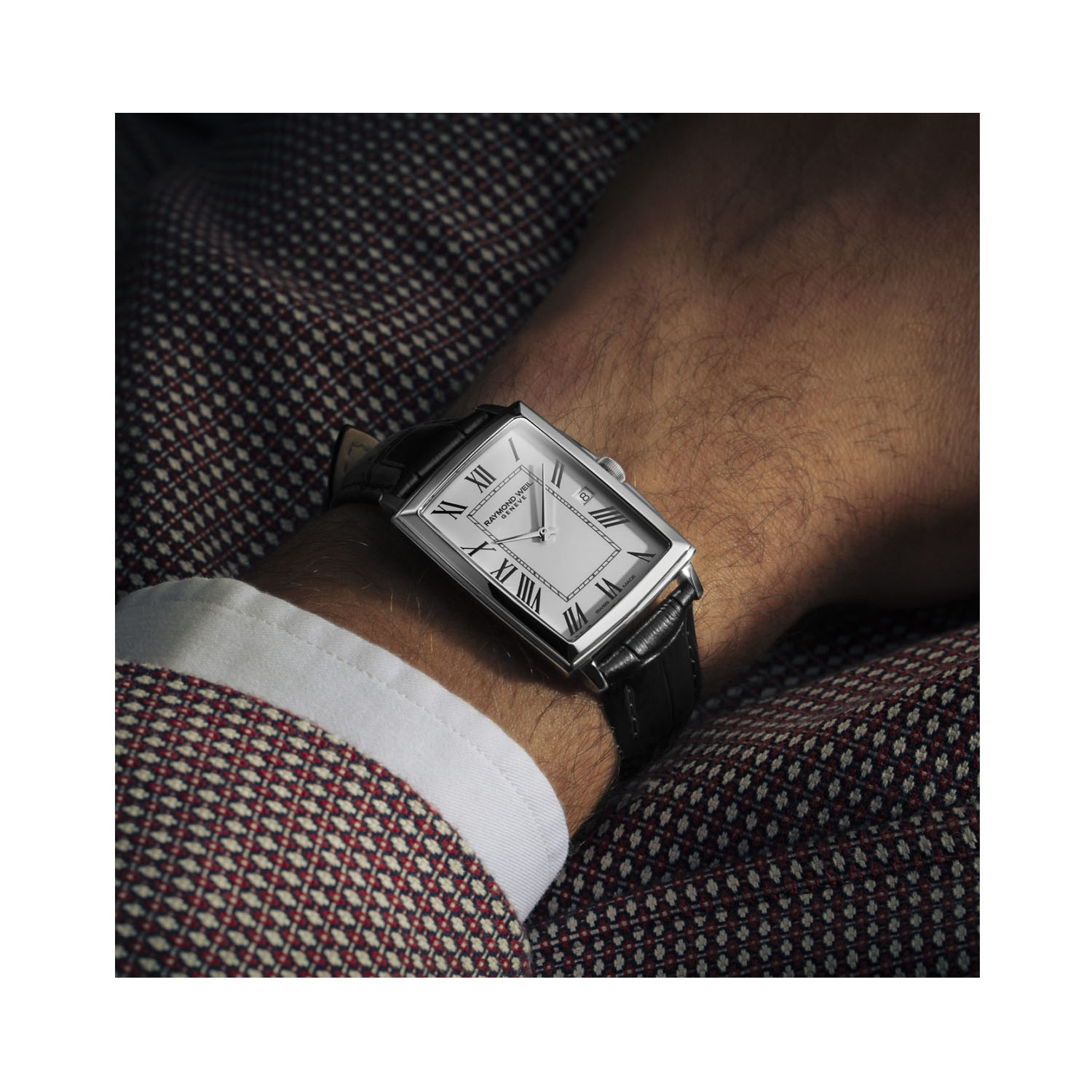 Raymond Weil, Toccata with a 29 x 37mm rectangular steel dial with a black leather strap featuring a date function and a white dial.