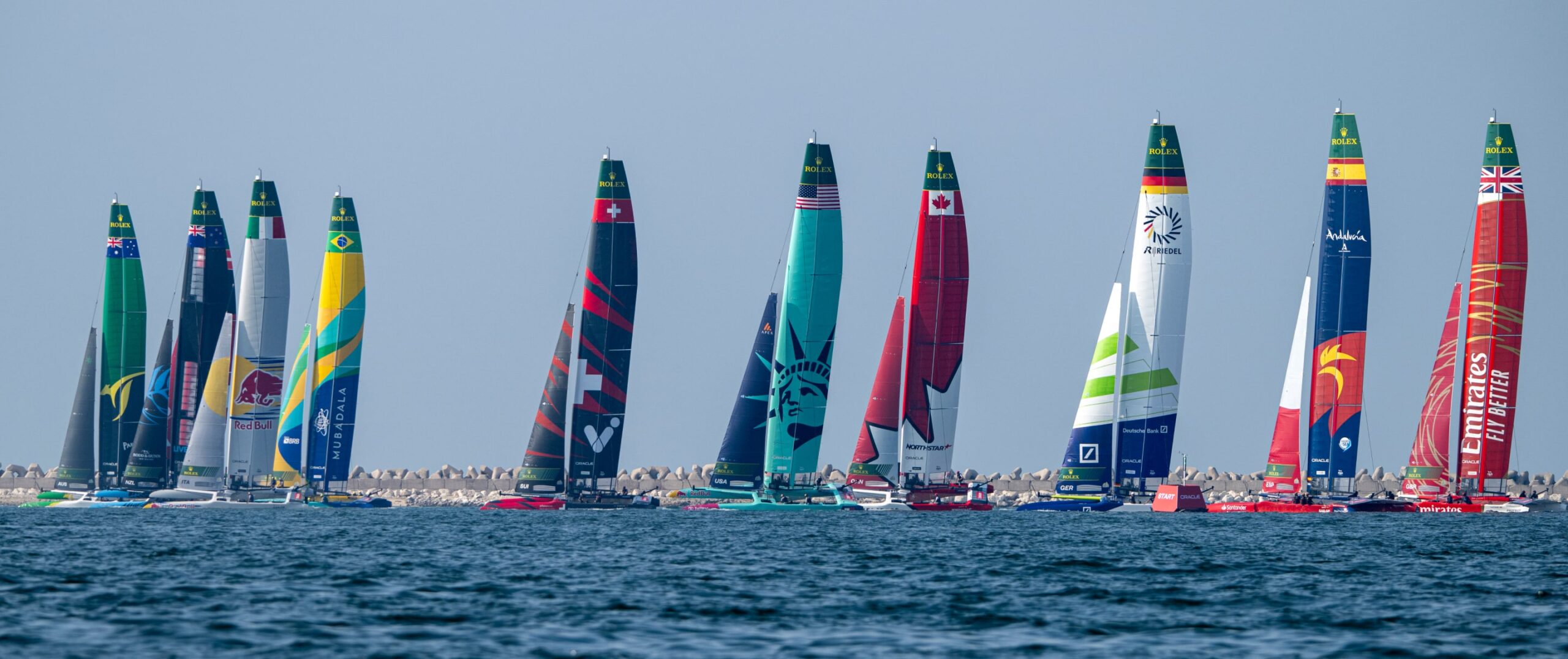 Line up of sail boats in sea
